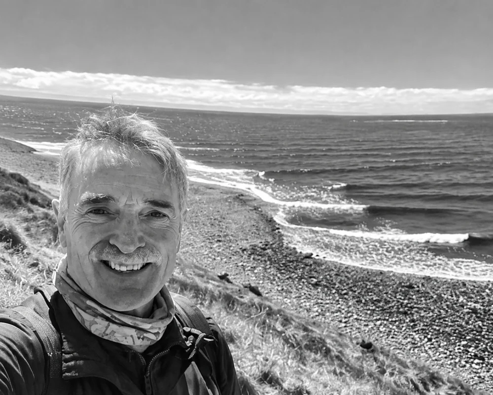 Andrew Mai smiling at Lawrencetown Beach, Nova Scotia
